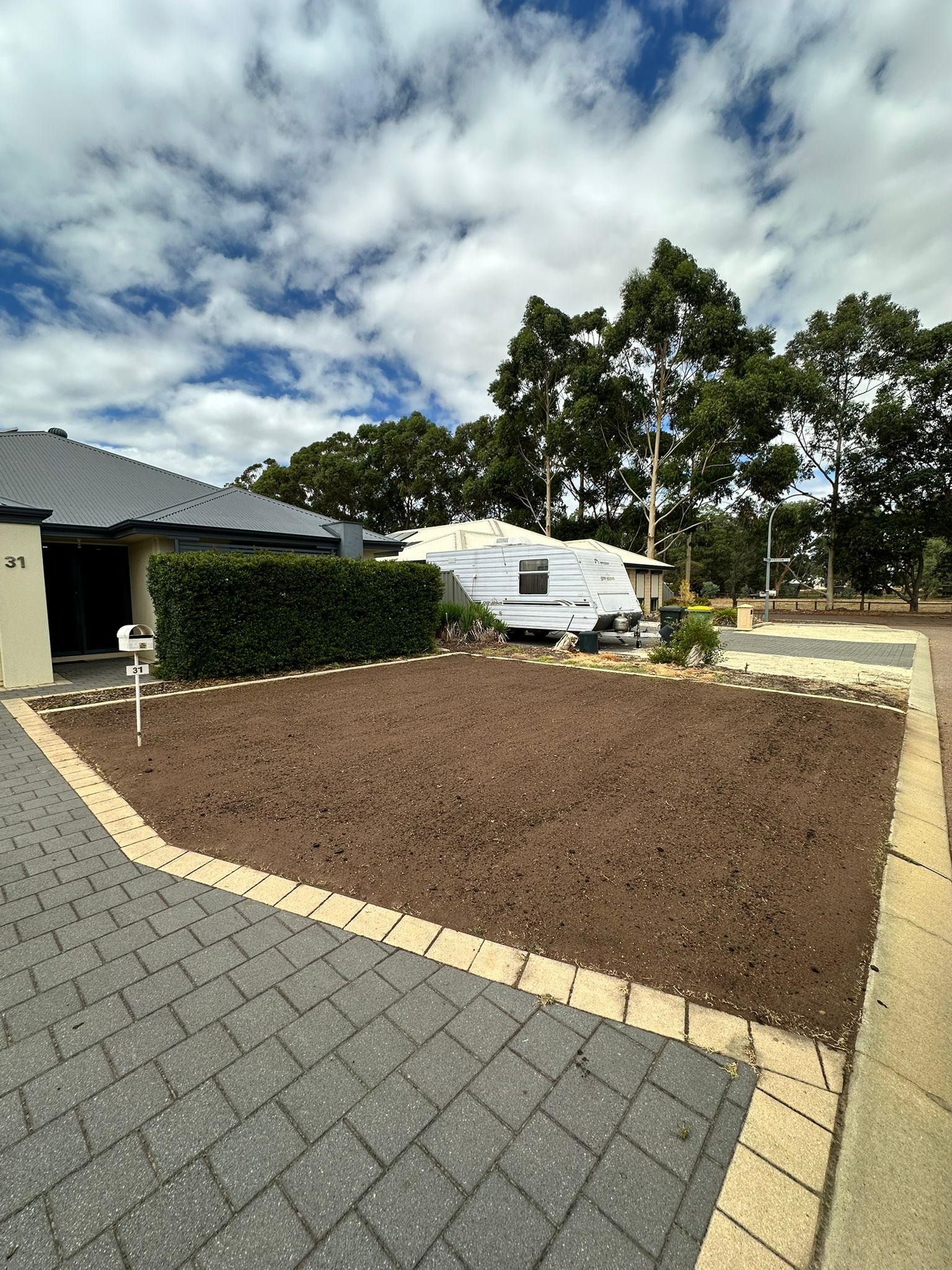 Perth front lawn with a fresh soil blend worked across the surface