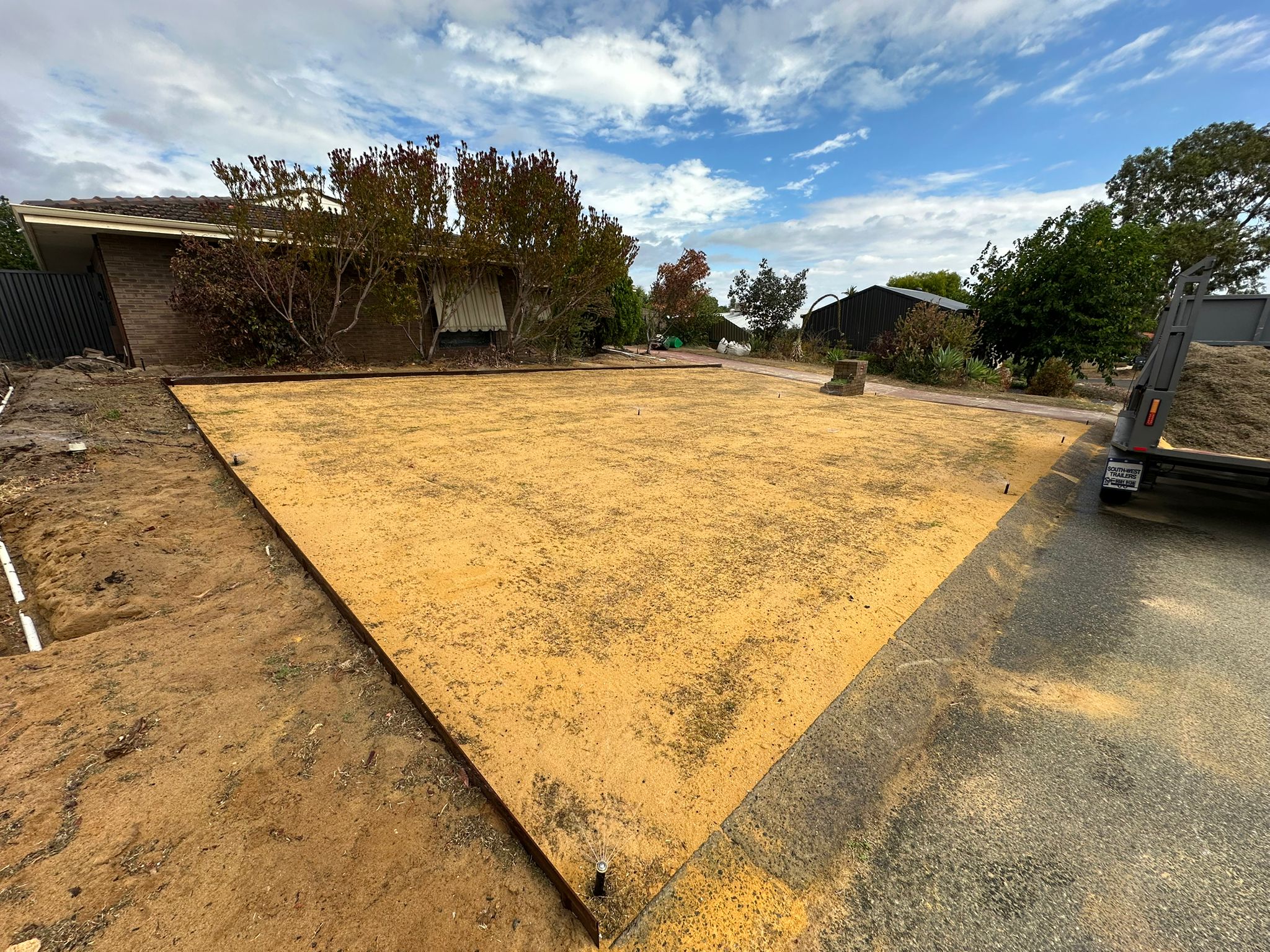 Soil blend spread evenly over a levelled lawn